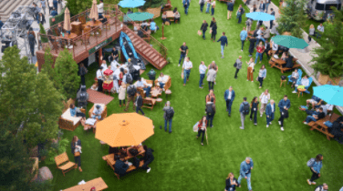 People walking through the grass at a fair